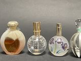 several different types of perfume bottles are lined up on a table