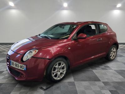 la petite voiture rouge est garée sur un sol en damier