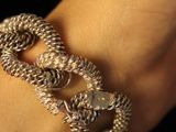 a close up of a person ' s hand wearing a bracelet