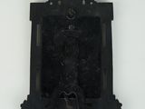 a black clock hanging on the wall with a white background