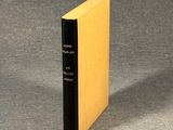 the book is sitting on a gray surface with a black cover