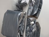 three bags of luggage sitting on top of a white wall