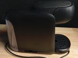 a coffee maker that is sitting on a wooden table