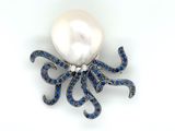 an octopus brooch with a pearl and blue sapphires