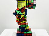 a sculpture of a rubik cube on a table