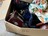 a cardboard box filled with assorted items sitting on the floor