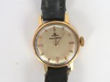a watch that is sitting on a black strap