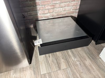 a metal drawer with a metal lid in the corner of a kitchen