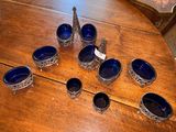 a wooden table with a bunch of blue bowls on it