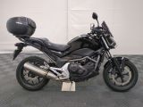 a picture of a black motorcycle parked on a checkered floor