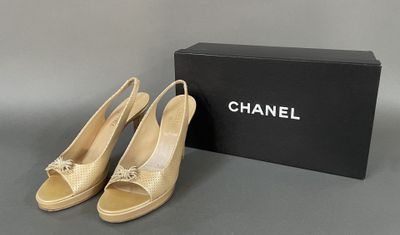 a pair of chanel shoes sitting next to a box
