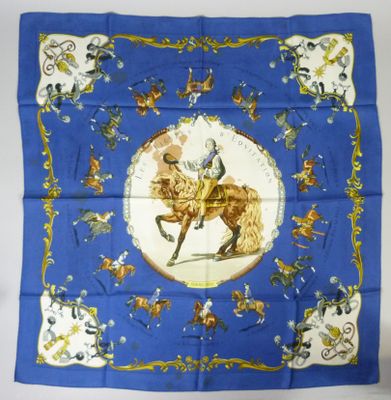 an image of a blue scarf with a picture of a man on a horse