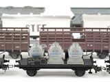 four toy trains that are lined up on the tracks