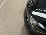 a sticker on the hood of a car that is parked on the side of the road