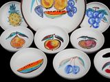 a lot of plates that have different designs on them