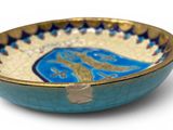 a blue and gold bowl with a picture of a horse on it