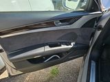 the door of a car with the driver ' s door open