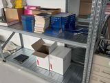 many boxes and boxes on a shelf in a room