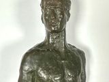 a bronze statue of a man holding a tennis racquet
