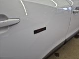 a close up of a white car with a sticker on the door