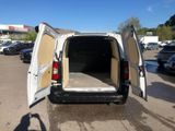 a white van with its doors open in a parking lot