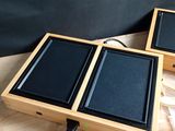 two speakers that are sitting on top of a wooden table