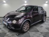 the nissan juke is parked in the garage on a checkered floor