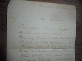 un vieux morceau de papier avec une écriture dessus, posé sur une table