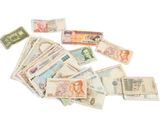 a pile of money sitting on top of a white table