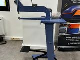 the machine is sitting on a stand in front of a poster
