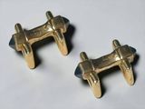 pair of gold plated cufflinks on a white surface