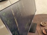a large flat screen tv sitting on top of a wooden table