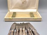 six silver plated knives in a case and six knives in a box