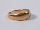a close up of a gold ring with a diamond on it