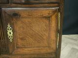 a wooden cabinet with a drawer on top of it