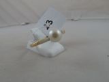 a small white ring with a pearl bead on it