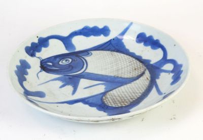 a blue and white bowl with a fish design on it