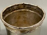 a silver cup that is sitting on a table