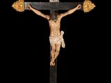 an image of a statue of jesus on the cross on a black background
