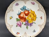 a close up of a plate with flowers on it on a table