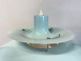 a light blue lamp that is on top of a table