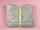 the large grey leather tote bag with a yellow zipper