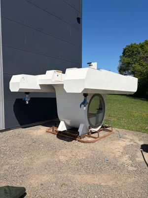 un grand objet blanc posé par terre à l'extérieur d'un bâtiment