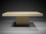 a square table with a concrete base on a dark background