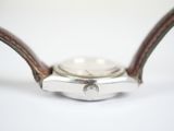 an image of a close up of a watch on a white surface
