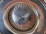 a close up view of a silver plate with a circular design