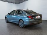 the rear end of a blue car parked in a garage