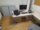 a desk with two computers and a laptop on it
