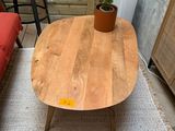 a wooden table with a potted plant on top of it