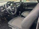 the interior of a car with the door open and the driver ' s seat up